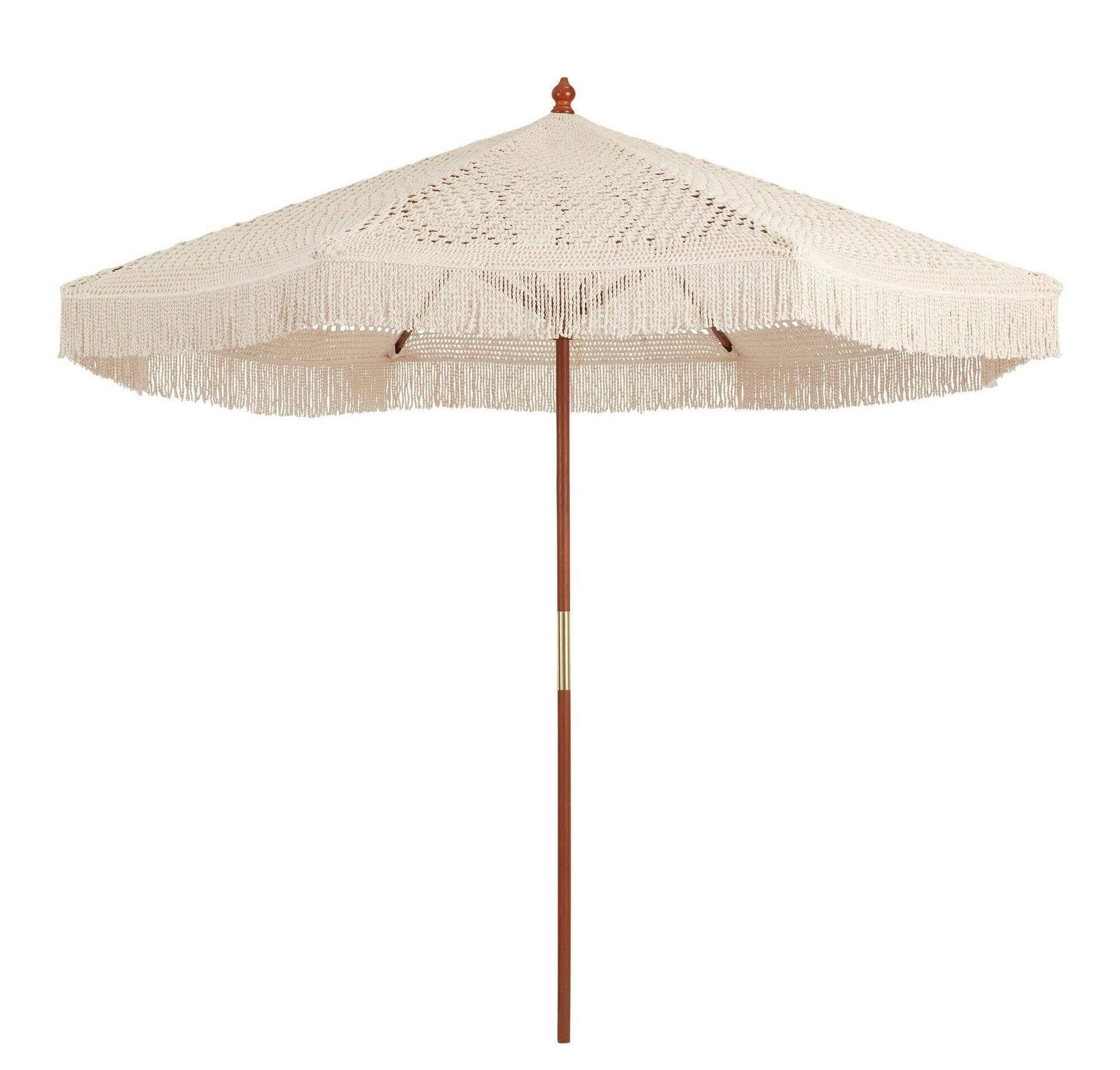 Beige patio umbrella with a wooden pole and fringe detail around the edges.