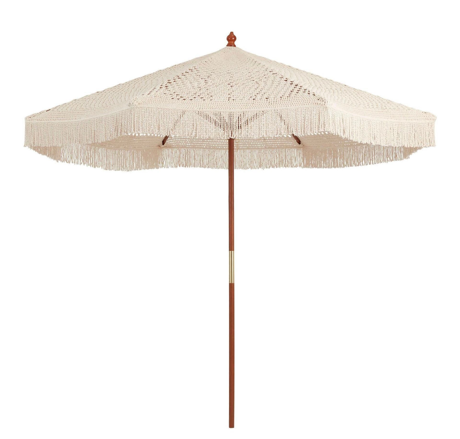 Beige patio umbrella with a wooden pole and fringe detail around the edges.