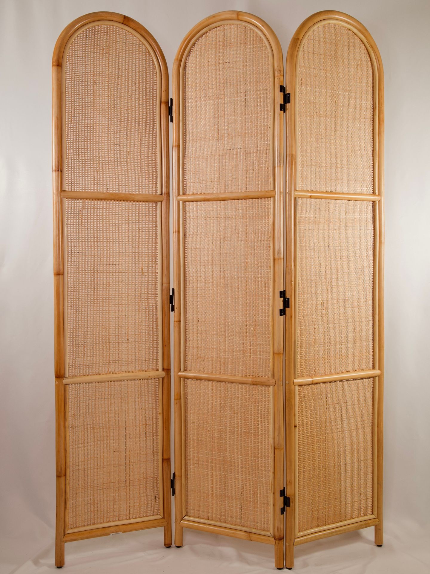 Three-panel wooden room divider with woven wicker material and curved tops, set against a plain background.