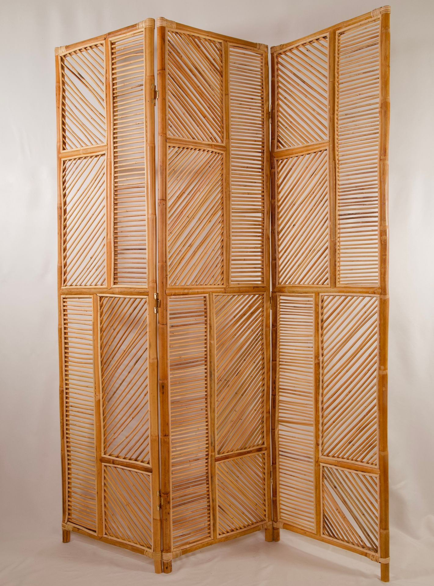 Foldable wooden room divider with a slatted design and diagonal patterns.