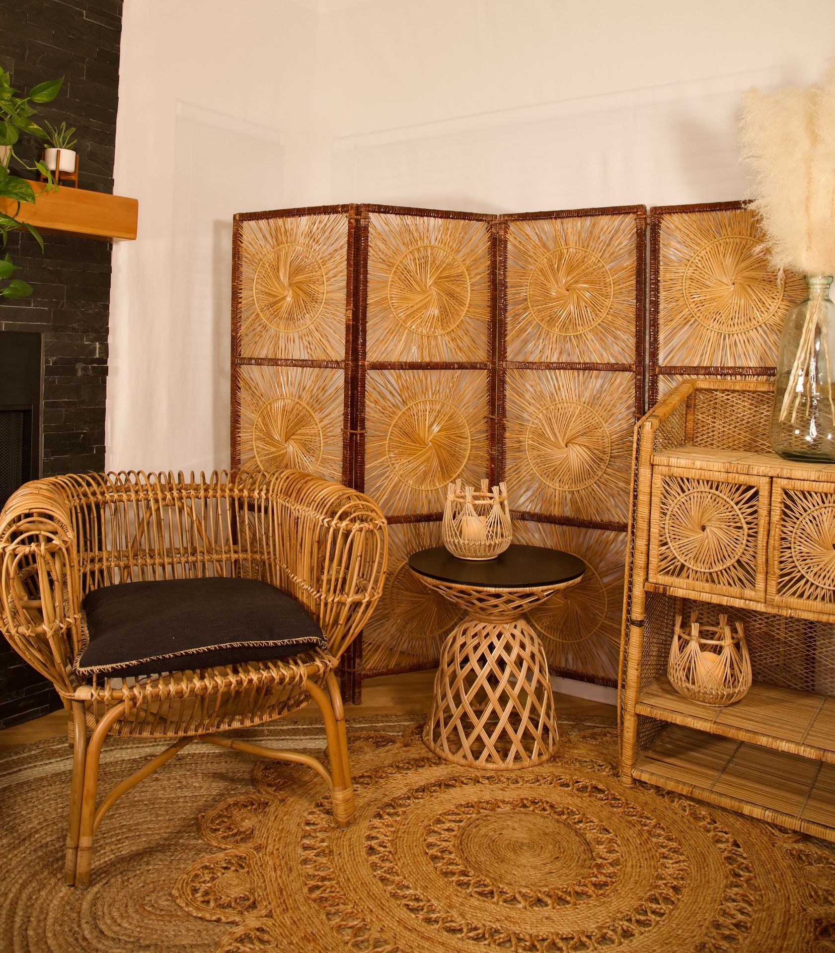 Cozy room with rattan furniture, woven screen, and a decorative rug.